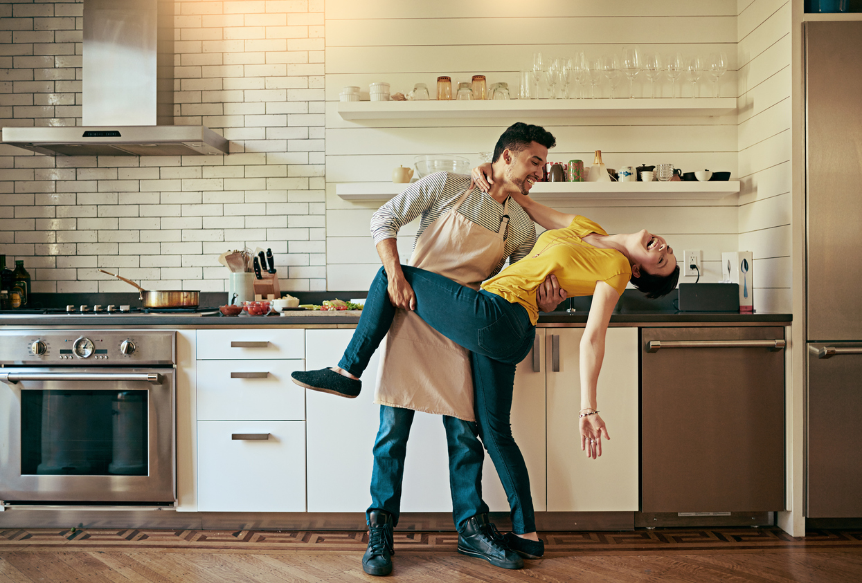 man dipping woman in dance pose in the kitchen